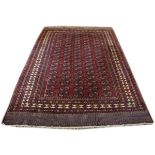 Modern Turkoman style rug typically decorated with rosettes on a red ground within multi borders,