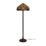 Tiffany style standard lamp with stained glass mushroom shaped shade, over bronzed spiral column