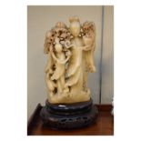 Chinese carved soapstone figure of a maiden holding a vase together with attendant, on associated