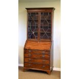 George III mahogany bureau and associated book case, the upper stage having a moulded dentil cornice