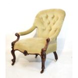 Victorian carved walnut framed spoon back deep buttoned easy chair with open arms on scroll supports