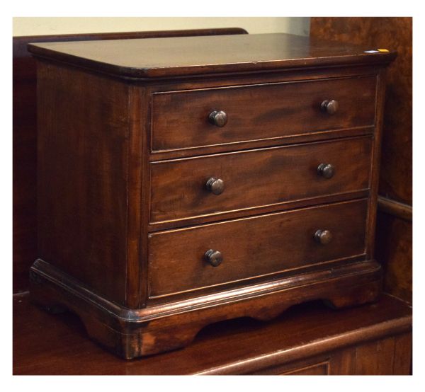 Victorian mahogany miniature chest of three long drawers on shaped apron Condition: