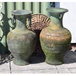 Two Eastern style terracotta coloured garden urns, one with ring handles, together with a circular