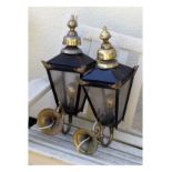 Pair of wall mounting hall lanterns with brass scroll fittings and black painted frames Condition: