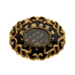 19th Century yellow metal oval mourning brooch having enamelled decoration with script 'In Memory'