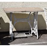 White painted cast iron Singer sewing machine base with later rectangular granite top Condition: