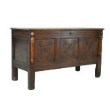 18th Century oak coffer, the triple panel front having carved stylised foliate decoration Condition: