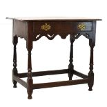 Early 18th Century oak side table, the overhanging rectangular top over single drawer and shaped