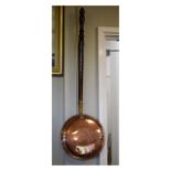 19th Century copper bed warming pan with brass collar and turned fruitwood handle Condition: