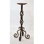Wrought iron pricket candlestick having a wavy fluted dished drip tray on open spiral support and