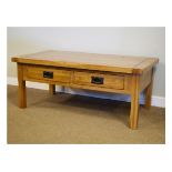 Modern light oak two drawer coffee table with rectangular top on square section supports Condition: