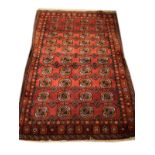 Good quality modern Middle Eastern rug decorated with rosettes on a red ground within multi