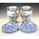 Pair of Noritake Japanese porcelain two handled vases depicting figures in waterside pavilions,