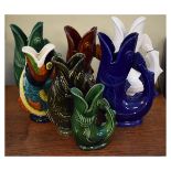 Collection of seven pottery fish gurgle jugs by Dartmouth Pottery to include: four made for Shreve
