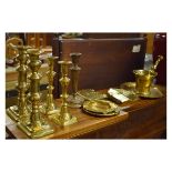Group of assorted brass ware to include; two pairs of candlesticks, one of ejector type, two