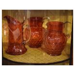 Three early 20th Century cranberry glass jugs Condition: