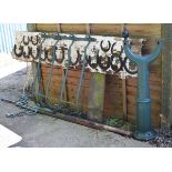 Selection of equestrian related items to include; two green painted metal poles, each with scroll