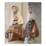 Two Lladro figures, each depicting a young Spanish girl in traditional costume Condition: