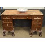 Early 20th Century mahogany kneehole desk having an inset leather writing surface, fitted nine