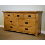 Modern light oak side cabinet or dresser base, the rectangular top over three short and two
