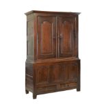 Early 18th Century oak two stage press cupboard, the upper section fitted two doors having fielded