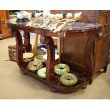 Modern mahogany console table having a bevelled plate glass top within D shaped frame on leaf carved