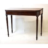 Early 19th Century mahogany fold-over tea table, the rounded oblong top on four turned tapering