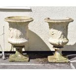 Large pair of reconstituted stone garden urns of campana form moulded with figures on fluted socle