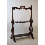 19th Century mahogany boot and crop rack having a shaped top rail with carry handle and eight