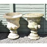 Pair of reconstituted stone garden urns of campana form with mask handles Condition:
