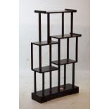 Set of 20th Century Oriental hardwood miniature open shelves of asymmetrical design Condition: