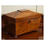 19th Century mahogany sarcophagus shaped tea caddy, the hinged cover opening to reveal a fitted