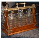 Nickel plated mounted oak tantalus containing three cut glass decanters ` Condition:
