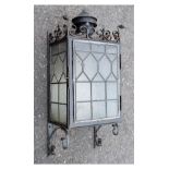 Early 20th Century wrought iron wall lantern, with mottled glass door and sides all with lead
