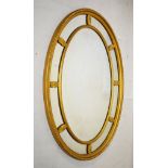Early 20th Century giltwood oval wall mirror having central oval plate within partitioned surround
