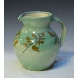 Fishley Holland jug having impressed leaf decoration on a pale green ground Condition: