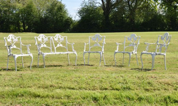 White painted metal five piece patio set comprising: two seater bench and three open arm chairs