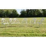 White painted metal five piece patio set comprising: two seater bench and three open arm chairs