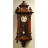 Vienna style walnut and beech cased mantel clock, the pediment decorated with a horse, glazed door