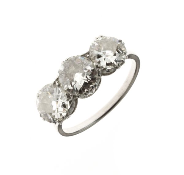 Three stone diamond ring, the white mount unmarked, the graduated old, brilliant cuts calculated