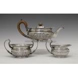 George V silver three piece tea service, each piece of squat circular form, gadrooned edge, half