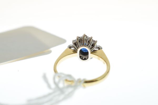 Diamond and sapphire 18ct gold ring, the oval cut sapphire enclosed by five brilliant cuts above - Image 6 of 7