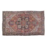 Caucasian wool carpet, the brick-red field with eight pointed star medallion within assorted flowers