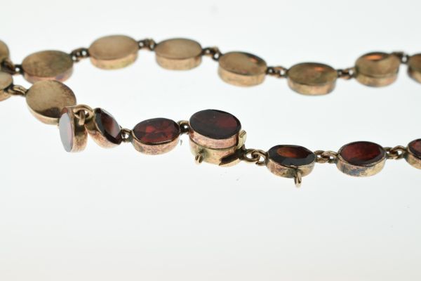 Garnet riviere necklace, the thirty-eight uniform oval cuts in closed back setting, approximately - Image 2 of 6