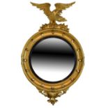 19th Century giltwood convex wall mirror, the circular plate within ebonised reeded slip and cavetto