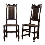 Pair of late 17th/early 18th Century oak hall chairs, each having scroll carved cresting over