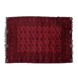 20th Century Middle Eastern wool rug, the brick-red field with four rows of eleven guls and