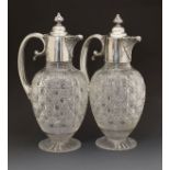 Pair of Victorian silver mounted glass claret jugs of ovoid form, each having hobnail cut decoration