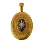 Victorian garnet and seed pearl set oval unmarked gold locket, circa 1870, the central cabochon star