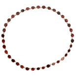 Garnet riviere necklace, the thirty-eight uniform oval cuts in closed back setting, approximately